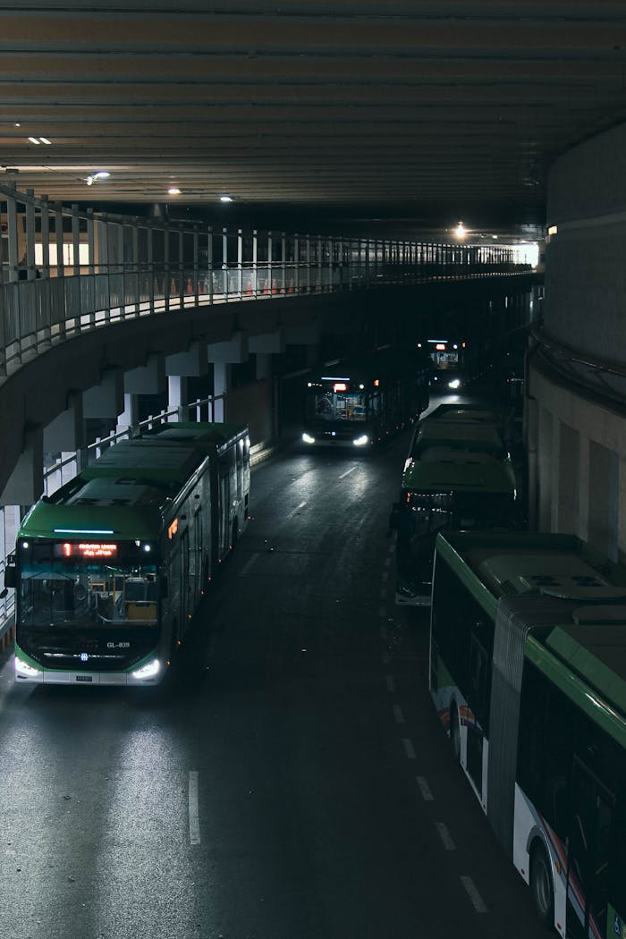 services-04 Multiple buses in an urban underpass at night in Karachi, Pakistan.
