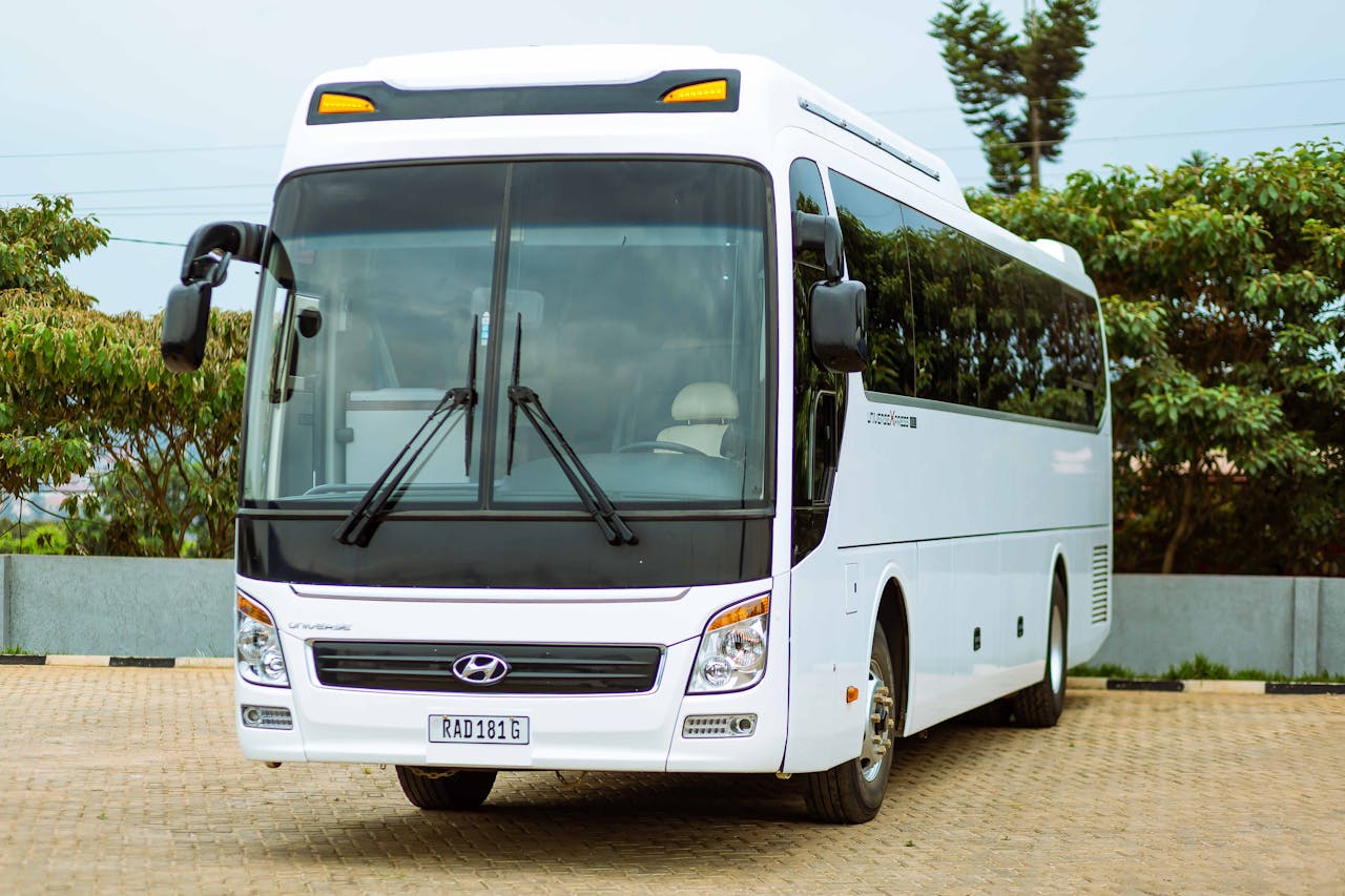 get-in-touch A white Hyundai bus parked outside on a paved surface, ideal for travel and transport themes.